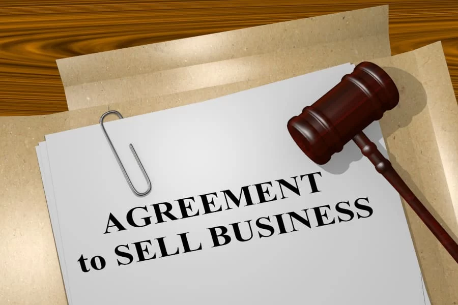 3D illustration of "AGREEMENT to SELL BUSINESS" title on legal document
